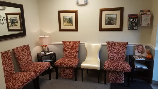 A room with four chairs and two lamps